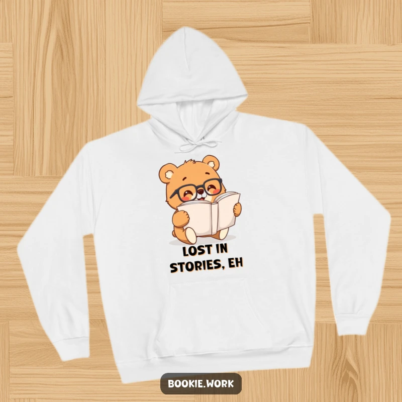 Funny bear with reading glasses enthusiastically turning pages of a large book, featured on a cozy hoodie.