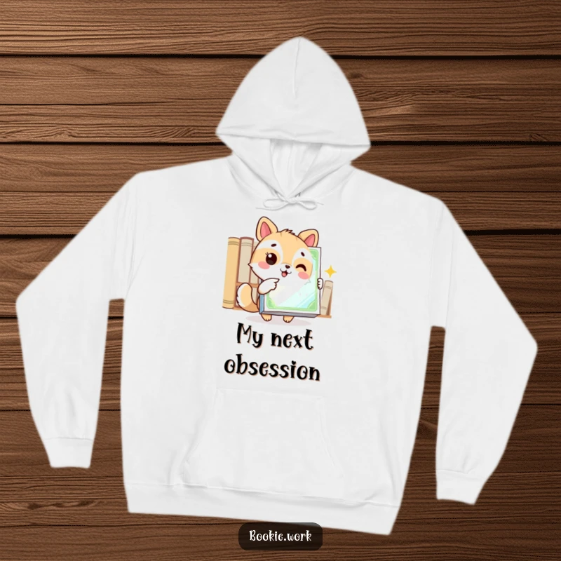 Funny hoodie featuring an excited animal character pointing at a gleaming book cover, ideal for cozy reading sessions.